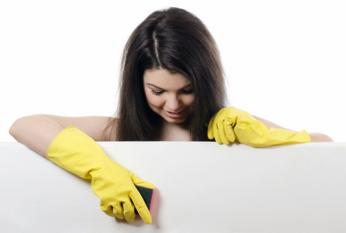 Professional cleaner preparing a short-let kitchen in NW11